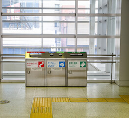 recycle  trash can (garbage bin) in japan train station. Japanese character tell about type of gabage to drop in such as paper, newsletter, bottle etc.