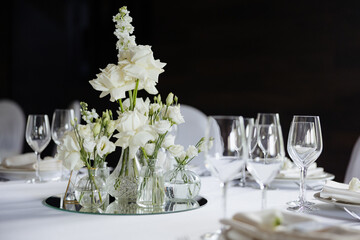 Elegant floral centerpieces enhance the dining experience in a sophisticated setting