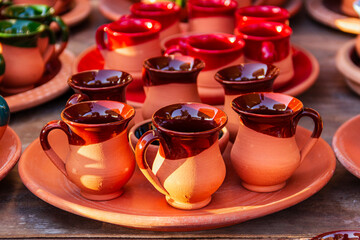 A clay coffee pot and cup set on the market stall.