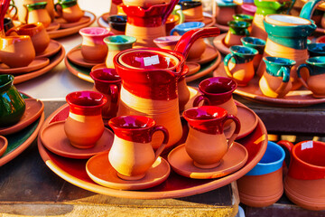 A clay coffee pot and cup set on the market stall.