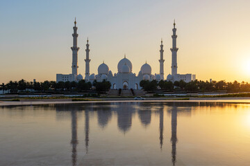 Sheikh Zayed Grand Mosque in Abu Dhabi at sunset. Stunning Islamic architecture, peaceful reflection on water, symbol of spirituality, culture, and UAE elegance. No people.