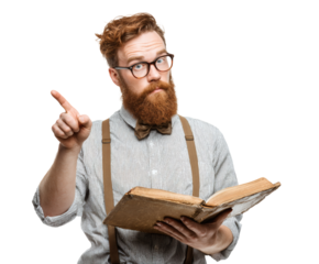 The serious hipster with a red beard and glasses is reading a book.