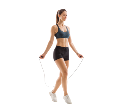 A woman in workout clothes is jumping rope during her exercise routine, showing her athletic ability.