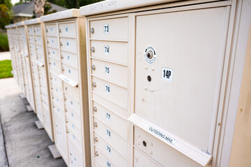Group of outdoor community mailboxes in residential neighborhood for postal delivery, housing services, and shared mail distribution.