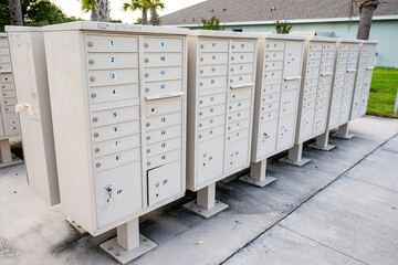 Group of outdoor community mailboxes in residential neighborhood for postal delivery, housing services, and shared mail distribution.