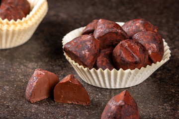Close-up of exquisite truffle candies in a charming paper basket