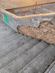 Old concrete steps with concrete and brick railing