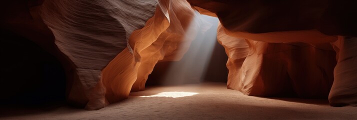 Obraz premium Sunlight illuminating sandstone cavern with dramatic light rays