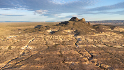 An epic aerial view of a remote, volcanic landscape under a clear sky. This dramatic and vast environment highlights the raw, untouched beauty of nature