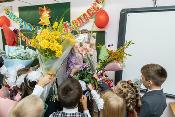 Russia. Saint Petersburg. Students giving flowers to a teacher on Knowledge Day.