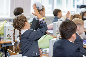 Russia. Saint Petersburg. Students raising their hands to answer.