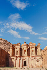 Obraz premium Petra, Jordan. Ancient rock temple stands majestically against a clear blue sky in desert landscape