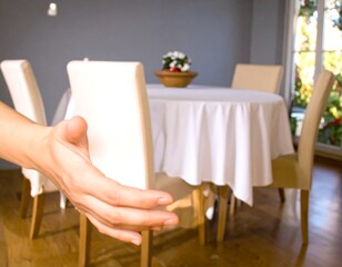 Hand reaching out in a dining room