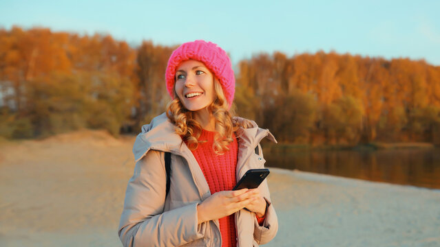 Travel, adventure, traveler woman with phone on the beach, girl holding smartphone on sea coast