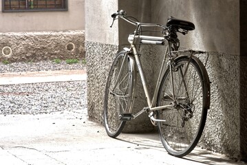 Fototapeta premium Old bicycle between the houses in the city.