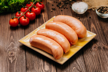 Tasty smoked sausages on rustic wooden background, ready for retail sale