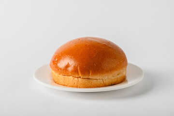 Fresh Round Brioche Bread on round white plate and White Background