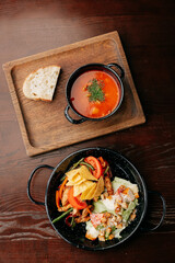 Traditional Ukrainian borscht with bread and chicken salad with vegetables and nachos