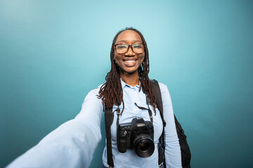 Pov of african american woman holding camera to record herself, grinning as she creates content in...