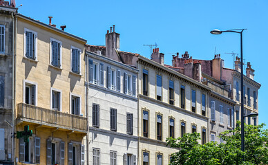 Row of classic apartment buildings, blue sky and pharmacy sign, rue de Lodi, Marseille, Mediterranean cityscape, Provence, France, rue de Lodi, Marseille
