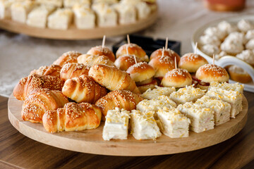 Delicious assortment of baked goods displayed on wooden platters at a festive gathering