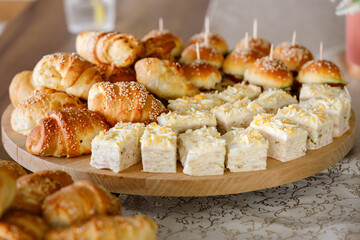 Delightful assortment of pastries and sandwiches at a midday gathering in a cozy setting