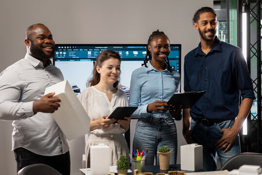 Portrait of multiethnic experts in real estate during collaborative meeting, analyze zoning regulations and site master plan for a property redevelopment project for infrastructure growth. - Powered by Adobe