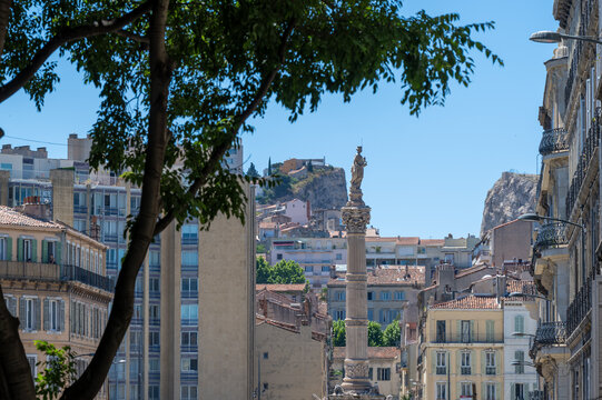 View of Castellane column and Marseille cityscape under a blue sky. Urban architecture, southern France, Marseille, France.