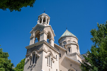 Fototapeta premium Marseille, France : Bell tower and dome of the Armenian Church on avenue du Prado against clear blue sky. Historic religious architecture in sunlight