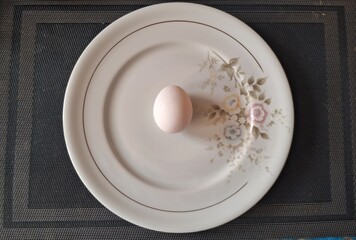 Egg on a decorative plate, top-down shot