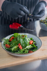 The chef prepares a salad. 