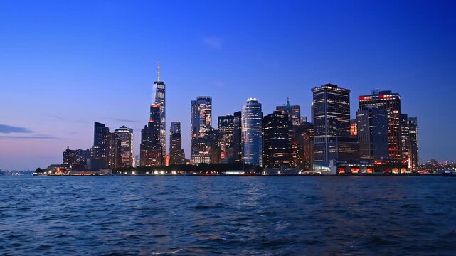 Fabulous Manhattan with dazzling illumination at night. View on New York skyline from the riverscape.