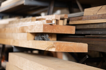 Stack of wooden planks stacked in warehouse in wood workshop