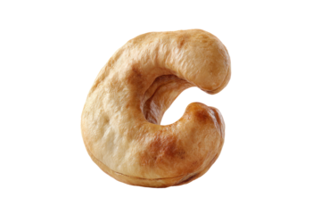 Close-up of a single, whole cashew.  Its light brown skin is visible, with a slightly uneven texture.  The cashew is shaped like the letter "C