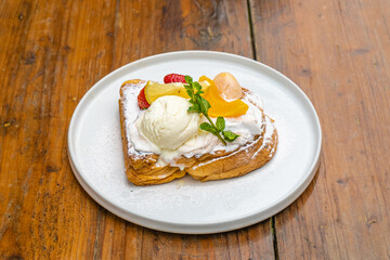 Delectable gourmet dessert with ice cream and fresh fruit on white plate, perfect treat