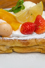 Freshly baked pancake dessert with vibrant summer fruits and whipped cream for cafe menu