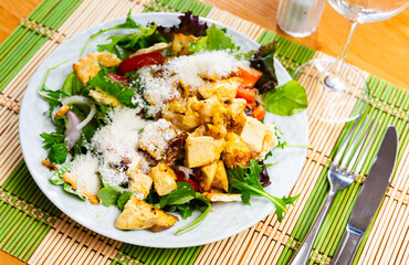 Variation of Caesar salad with chicken, lettuce mix and crackers