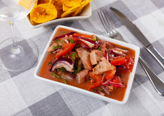 Delicious ceviche served with fried bananas in bowl for snack