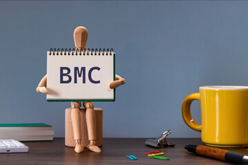 There is notebook with the word BMC. It is an abbreviation for Business Model Canvas as eye-catching image.