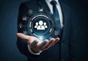 A person in a suit presenting a glowing, circular digital interface. At the center is an icon representing a team or customer base. This is surrounded by various business function icons such as securi