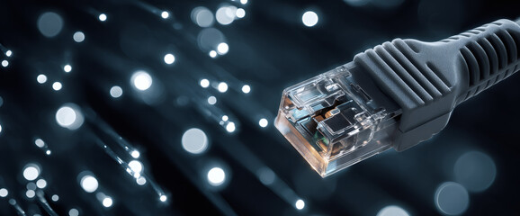 Ethernet cable with fiber optic light for network connectivity. Data transmission and digital communication concept. High speed internet connection.