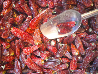 dried chili peppers with a metal scoop.