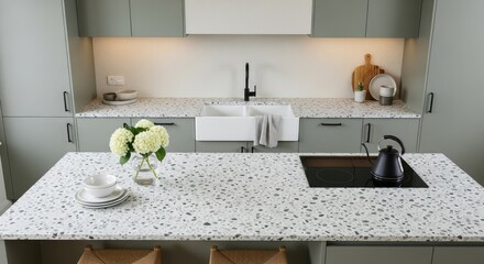 Modern kitchen island with terrazzo countertop, farmhouse sink, and stylish decor.
