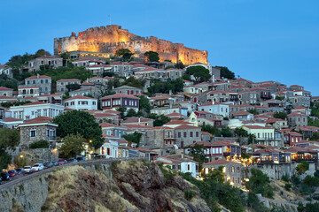 Historic houses and a castle on a hilltop in Molyvos on the island of Lesbos in the evening