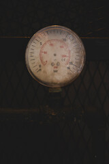 Vintage industrial pressure meter. Aged mechanical pressure indicator. Retro industrial pressure gauge. Old pressure gauge close up.