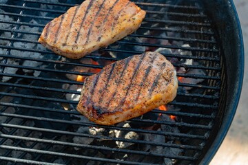 Grilled pork chops on a barbecue.