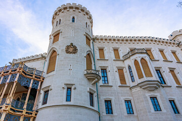 Obraz premium Historic european castle exterior with architectural details and blue sky backdrop