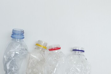 Group of plastic bottle waste with negative space on white background