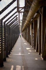 Industrial metal bridge passage with pipes