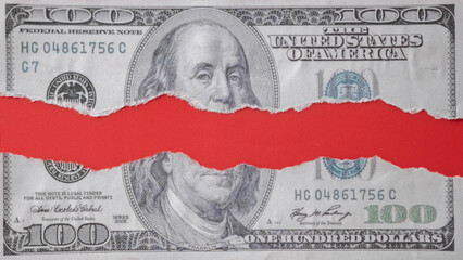Ripped hundred-dollar bill with red background in the middle. Symbolizes financial crisis, loss, inflation, economic downturn, bankruptcy, or broken financial system and risk.